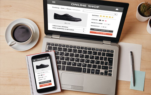 E-commerce-Shopping-Cart Iphone on top of a laptop with an online store open on both devices