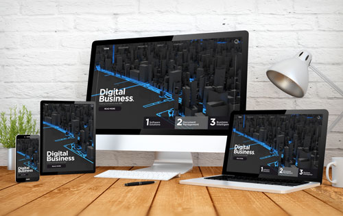 Laptop, Desktop, and mobile devices with a graphic on the screen "Digital Business"