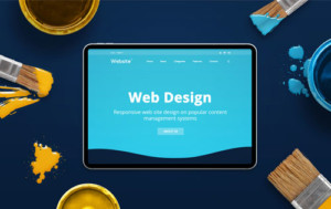 Tablet with a website open and "Web Design" text on screen