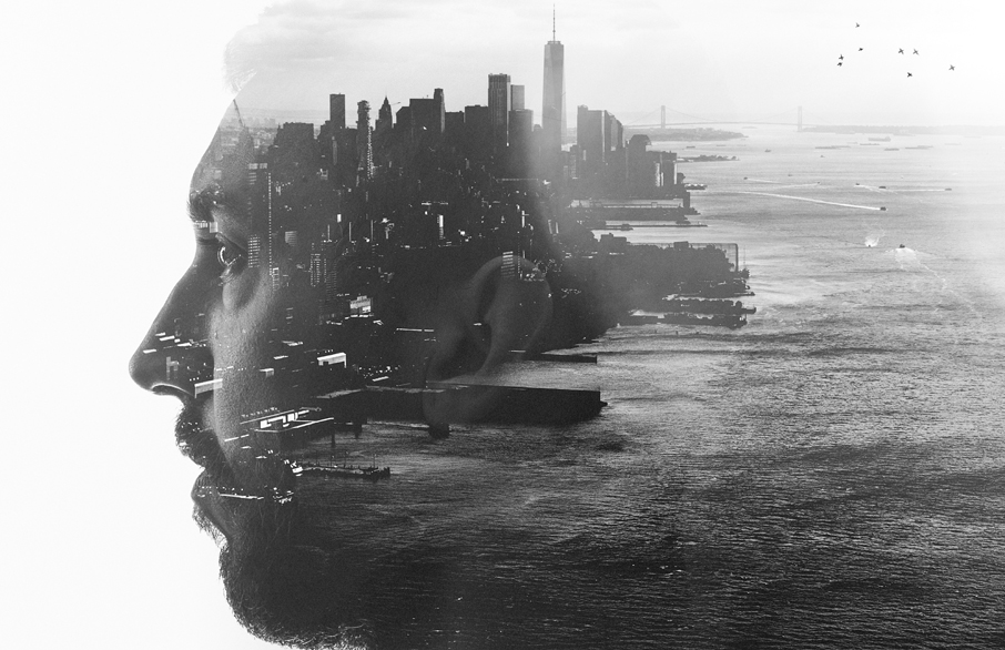 Two Worlds Web Design Services Double exposure portrait of a man with a waterfront city behind his face's silhouette